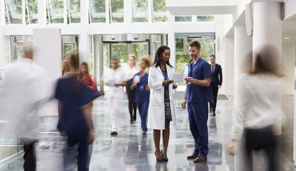 Medical professionals in busy corridor of healthcare building