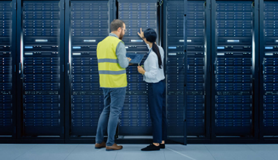 People in a data center secure room working on a server