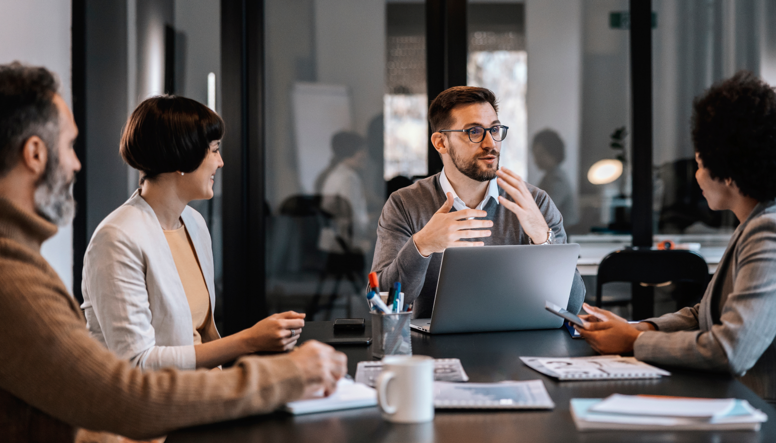 People talking around a conference table in an office