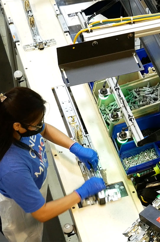 Allegion manufacturing personnel assembling product on the line. 